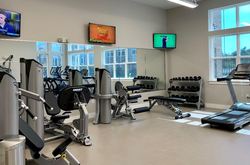 workout room with treadmills, weights, and other exercise machines.